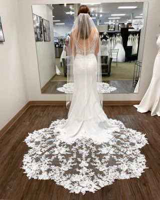Private design bridal gown with scalloped lace train by Lavish. Only at Emmy's Bridal